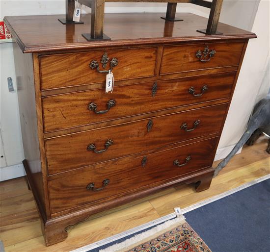 A George III mahogany chest fitted two short drawers and three long drawers on shaped bracket feet, with original gilt brass furniture